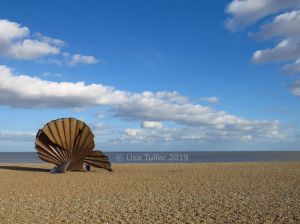 Colour photograph of The Scallop sculpture by Maggi Hambling on Aldeburgh beach